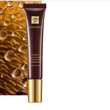 Cosmetic tube with gold cap on a textured brown background