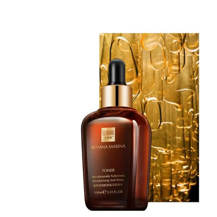 Brown skincare toner bottle with dropper and gold packaging on a white background