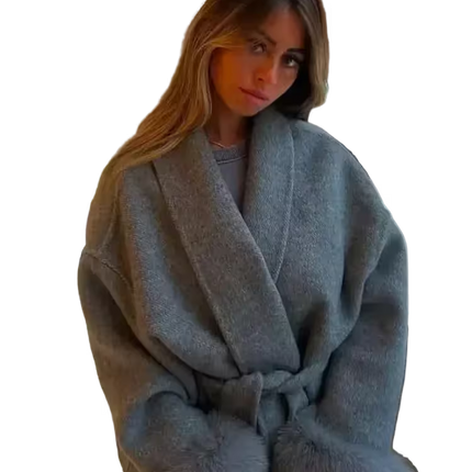 Woman wearing a light blue robe with fur trim on a white background