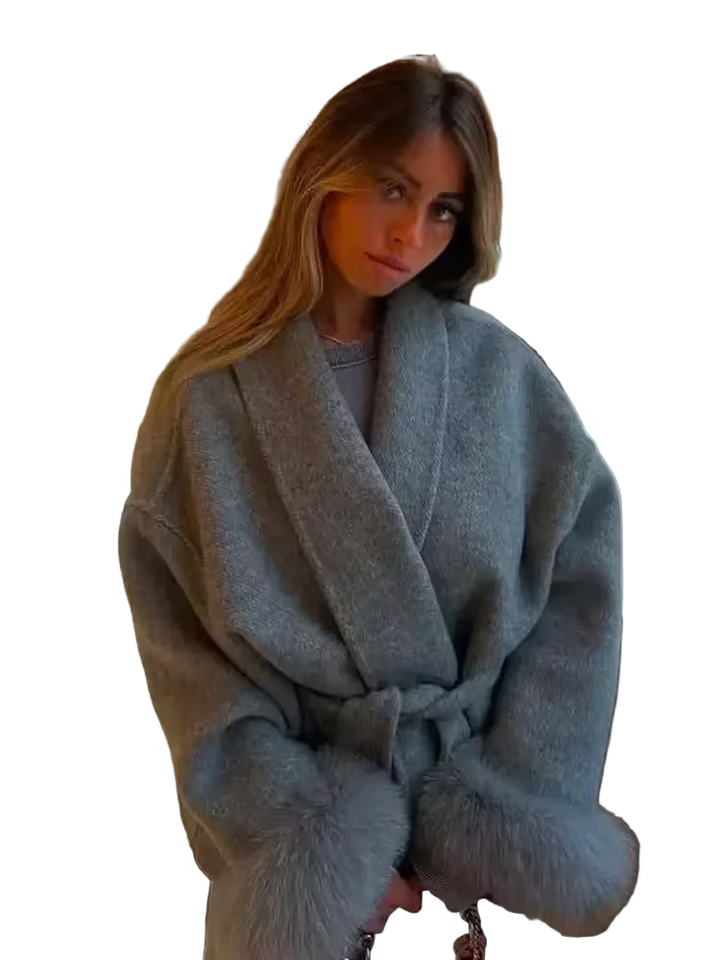 Woman wearing a light blue robe with fur trim on a white background