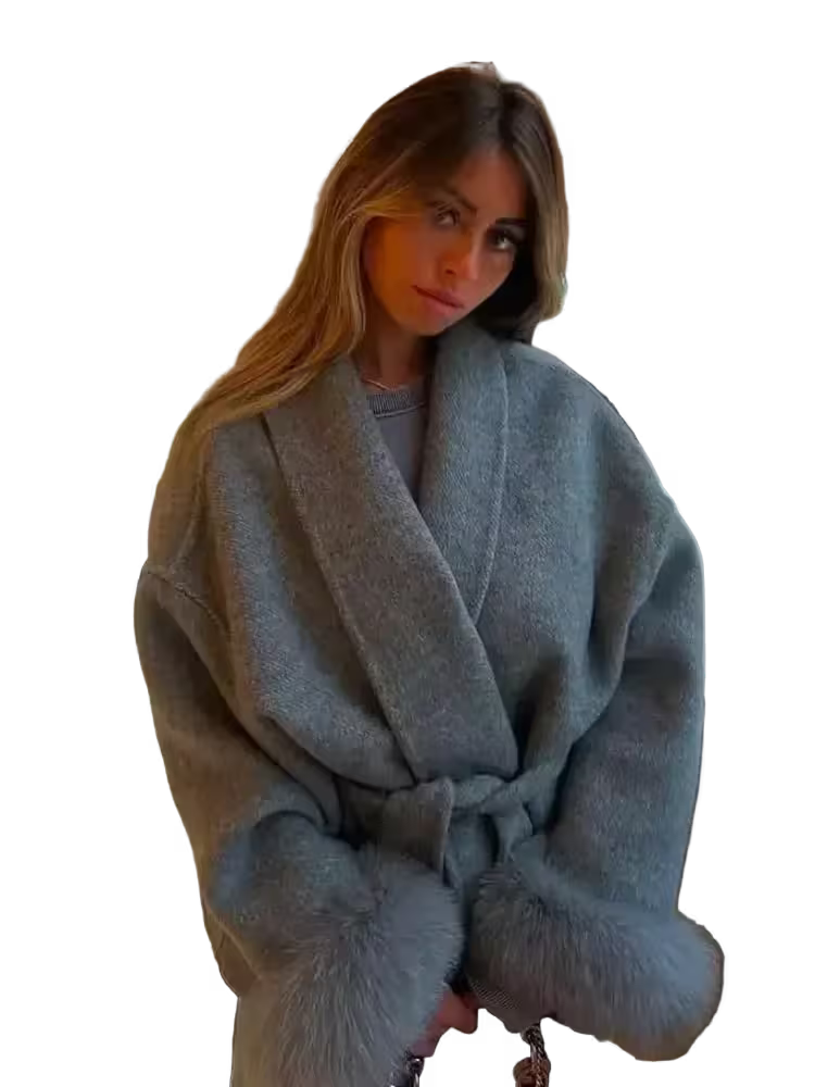 Woman wearing a light blue robe with fur trim on a white background
