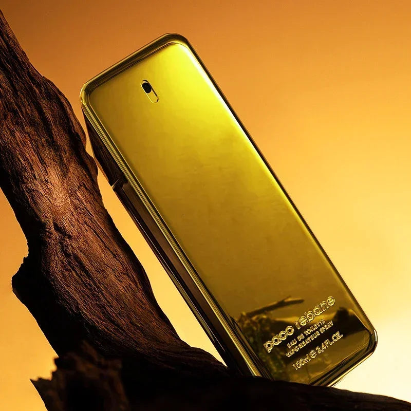 Gold phone case on a wooden surface with a warm yellow background