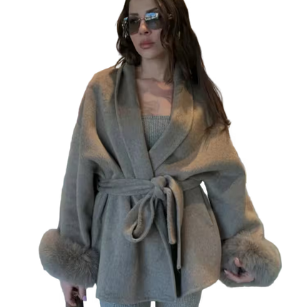 Woman wearing a gray coat with fur trim on a transparent background