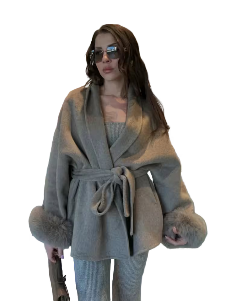 Woman wearing a gray coat with fur trim on a transparent background