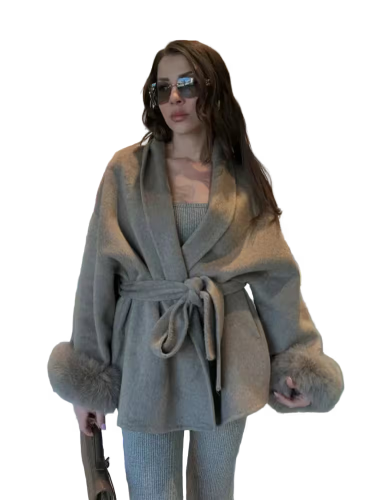 Woman wearing a gray coat with fur trim on a transparent background