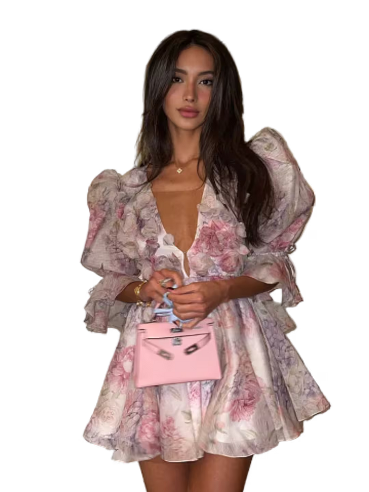 Woman in a floral dress holding a pink handbag on a transparent background