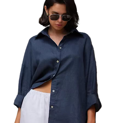 Woman wearing a navy blue shirt and white pants with sunglasses on a transparent background