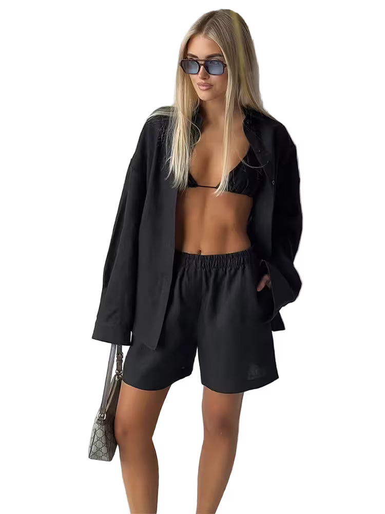 Woman in black outfit with sunglasses on a white background