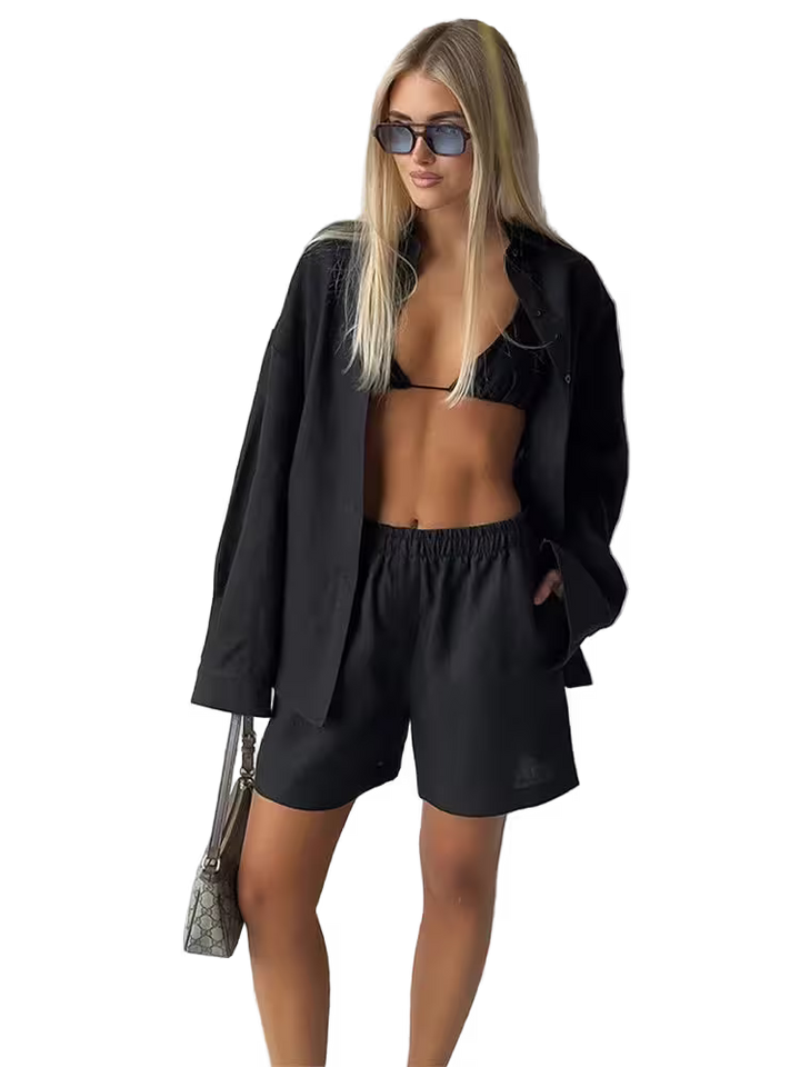 Woman in black outfit with sunglasses on a white background