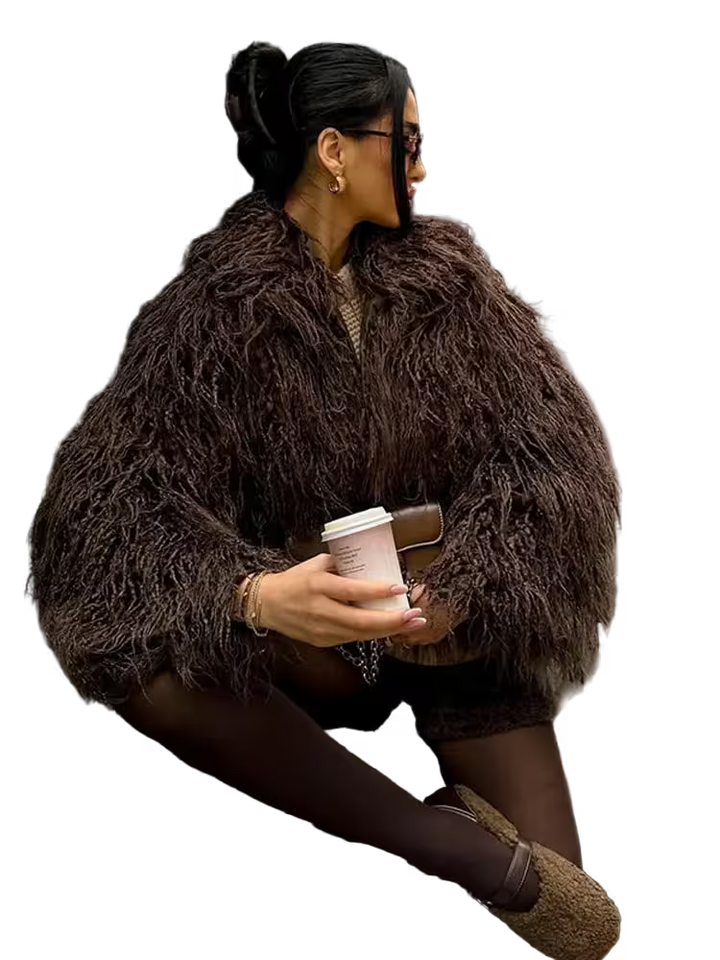 Woman in a brown fur coat holding a coffee cup on a white background