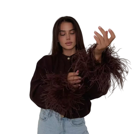 Woman wearing a brown textured sweater and light blue jeans on a transparent background