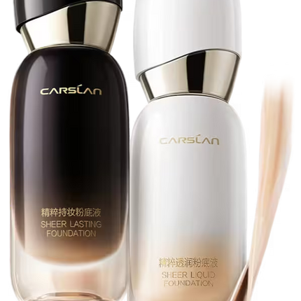 Two bottles of CarSLan foundation with a brush on a white background