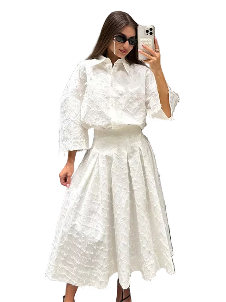 Woman wearing a white textured outfit taking a selfie on a transparent background