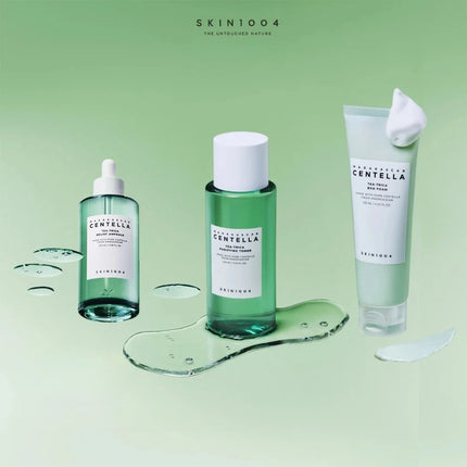 Three skincare products from SKIN1004 on a green background