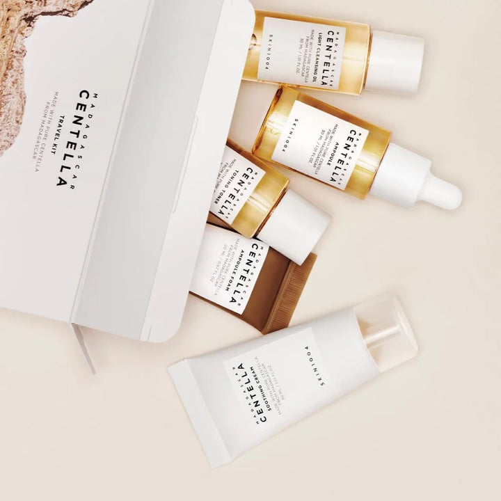 Set of Centella skincare products including bottles and a tube on a neutral background