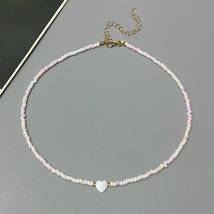 Necklace with heart-shaped charm on a gray surface