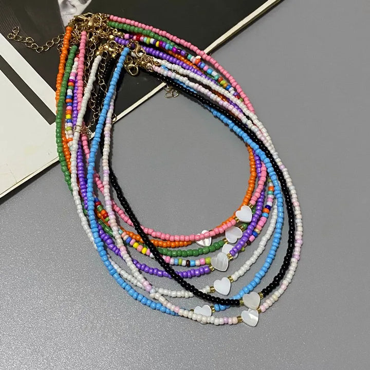 Colorful beaded necklace on a gray surface