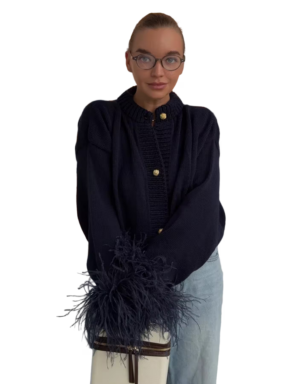 Person wearing a dark blue sweater with a fringed scarf on a white background