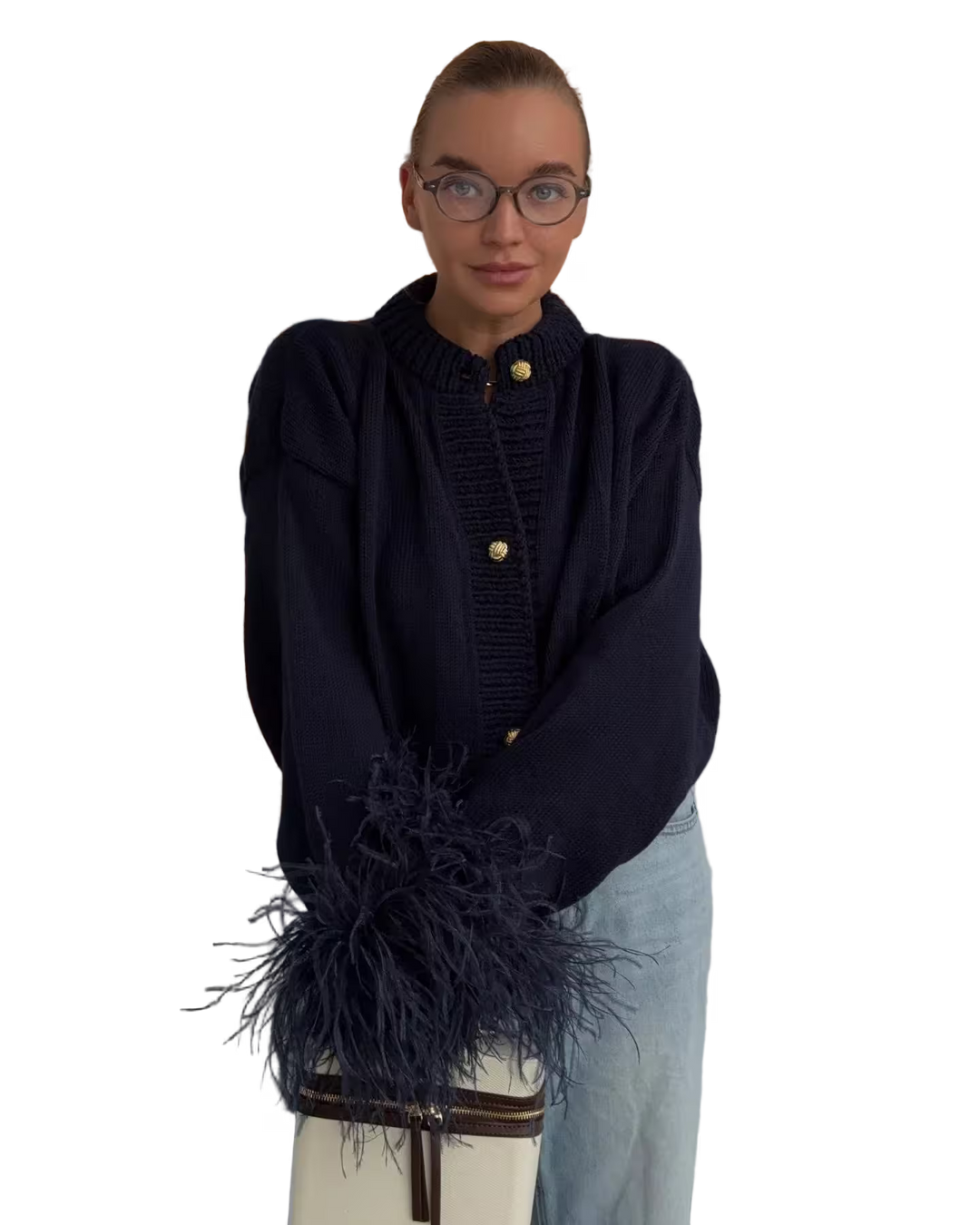 Person wearing a dark blue sweater with a fringed scarf on a white background