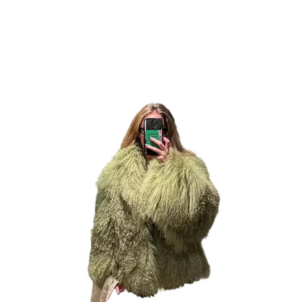 Person wearing a fluffy green coat against a white background