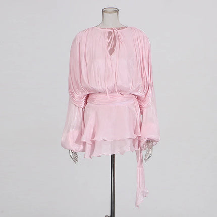 Pink dress on a mannequin against a gray background