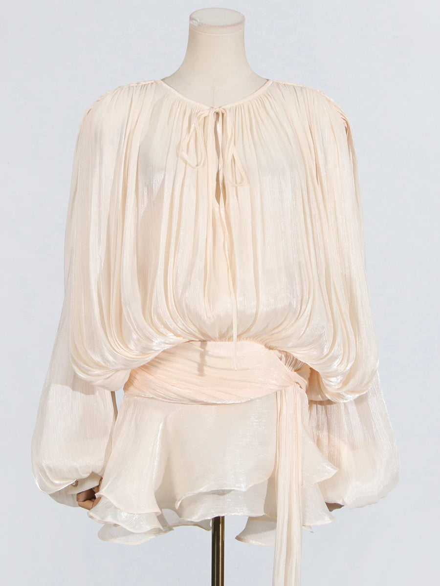 Cream-colored blouse on a mannequin against a light gray background