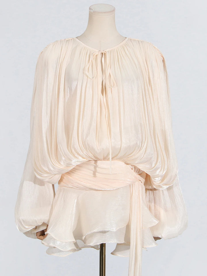 Cream-colored blouse on a mannequin against a light gray background