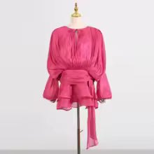 Pink dress on a mannequin against a white background