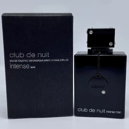 Black Armaf Club de Nuit Intense Man perfume bottle and packaging on a light gray background
