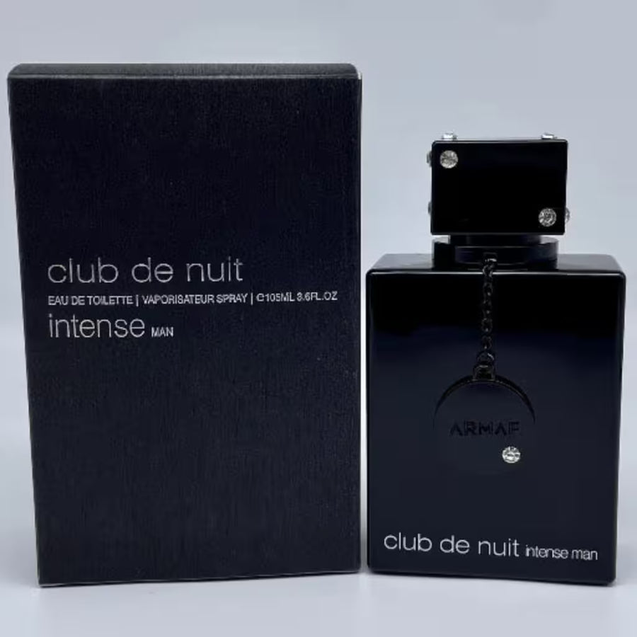 Black Armaf Club de Nuit Intense Man perfume bottle and packaging on a light gray background