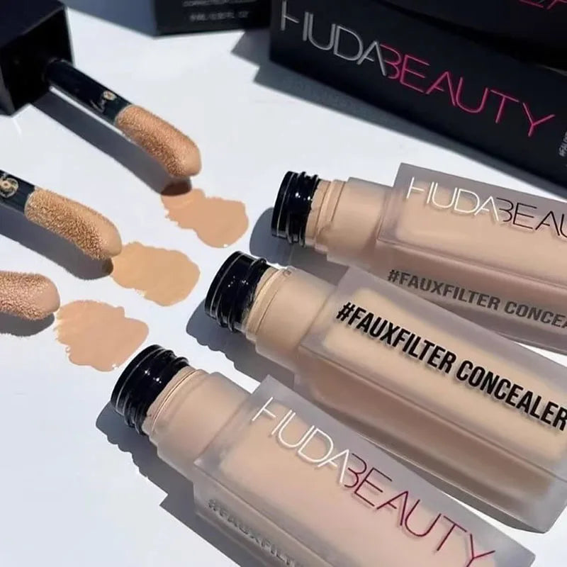 HUDA BEAUTY FauxFilter Concealer bottles with applicators on a white surface