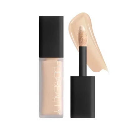 Concealer stick with applicator and swatch on a white background