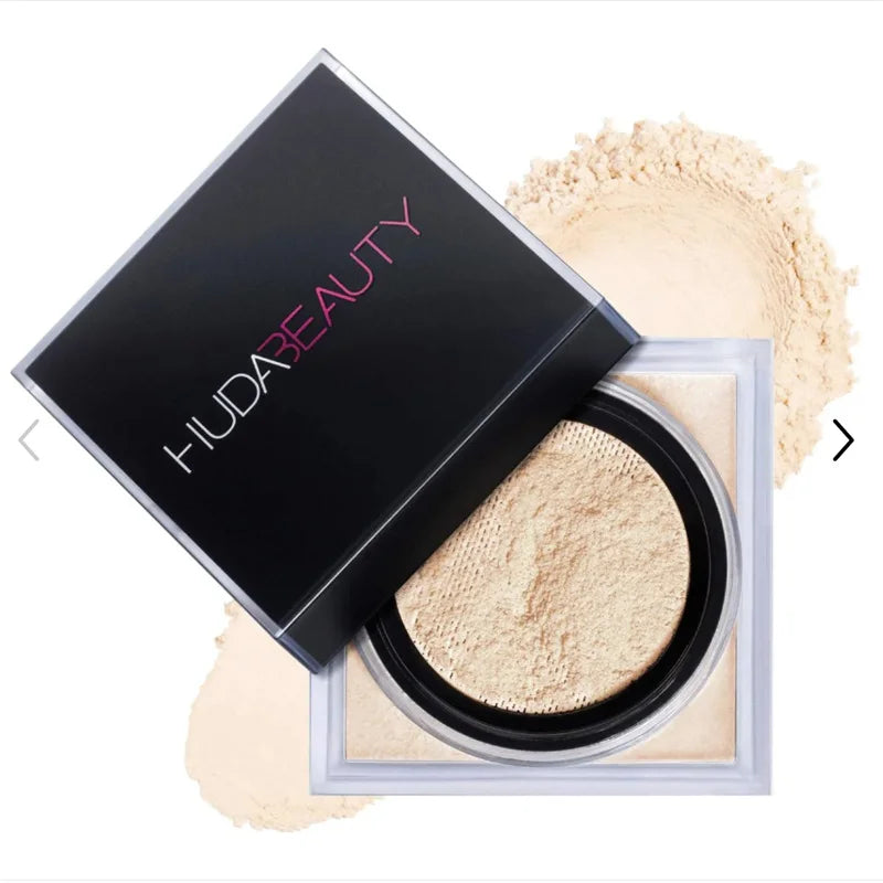 Huda Beauty powder compact with open lid showing light beige powder on a white background