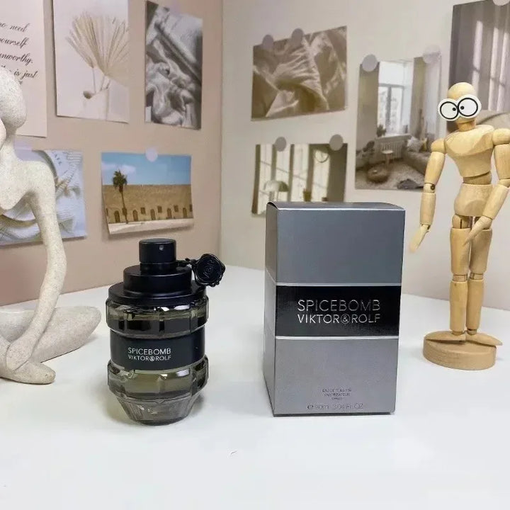 Spicebomb Viktor & Rolf perfume bottle and packaging on a surface with decorative items in the background.
