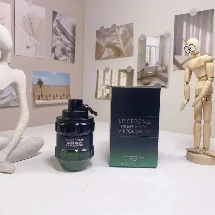 Spicebomb Night Vision Viktor & Rolf perfume bottle and packaging on a white surface with decorative items.