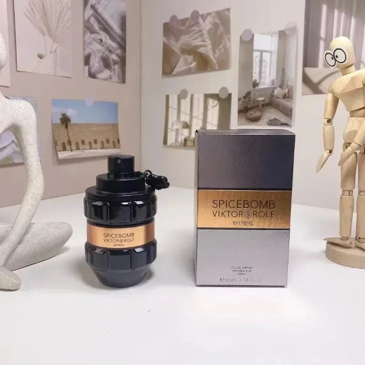 Spicebomb Viktor & Rolf perfume bottle and packaging on a white surface with decorative items in the background.