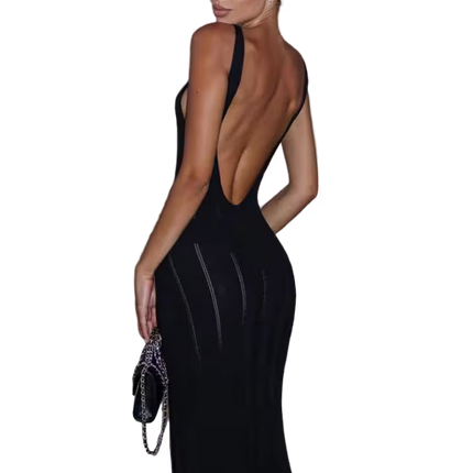 Woman wearing a black evening gown with a low back design, holding a clutch.