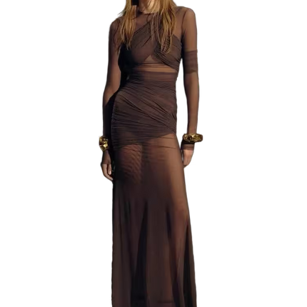 Woman wearing a brown dress with sheer panels on a white background