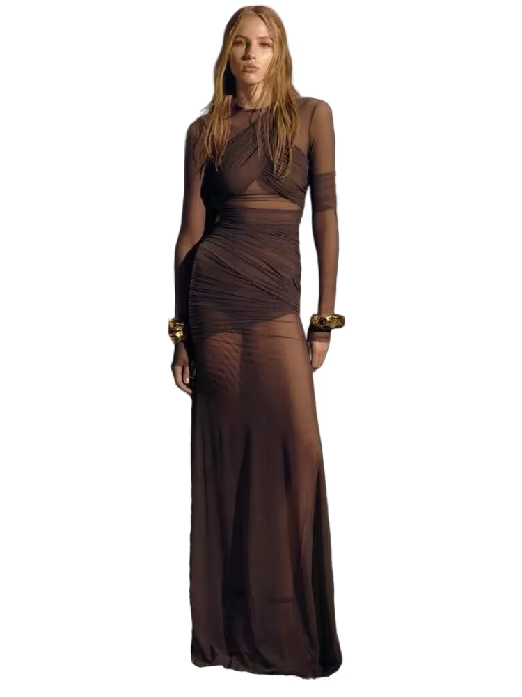 Woman wearing a brown dress with sheer panels on a white background