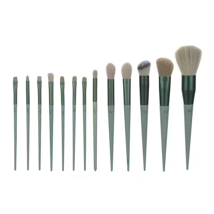Set of makeup brushes with green handles on a white background