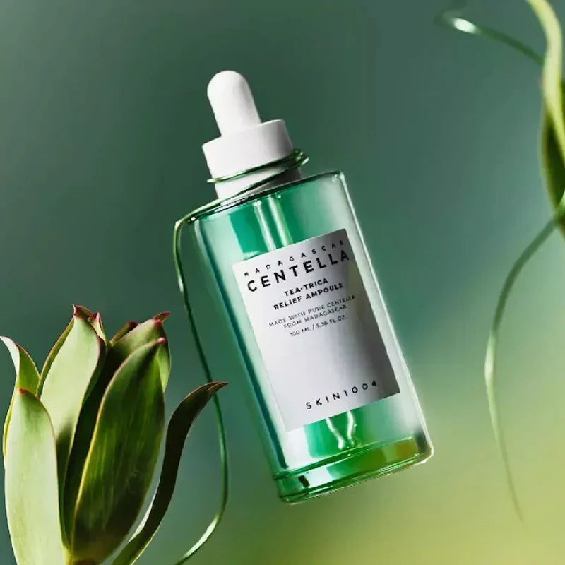 Skintelligence Centella Tea-Tree Relief Ampoule bottle with green liquid on a blurred green background