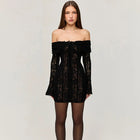 Black lace off-shoulder dress worn by a model on a plain background