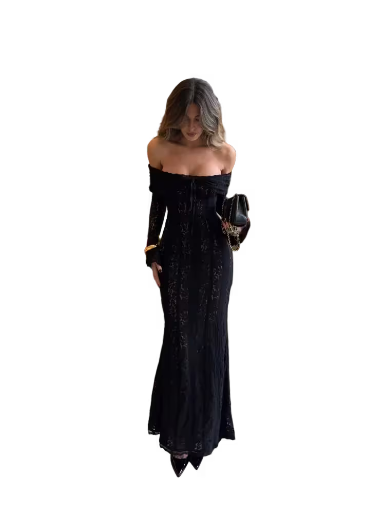 Woman wearing a black off-shoulder dress holding a black clutch against a white background