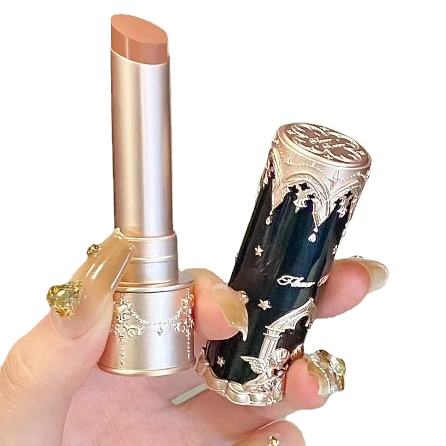 Decorative lipstick held by a hand with a white background